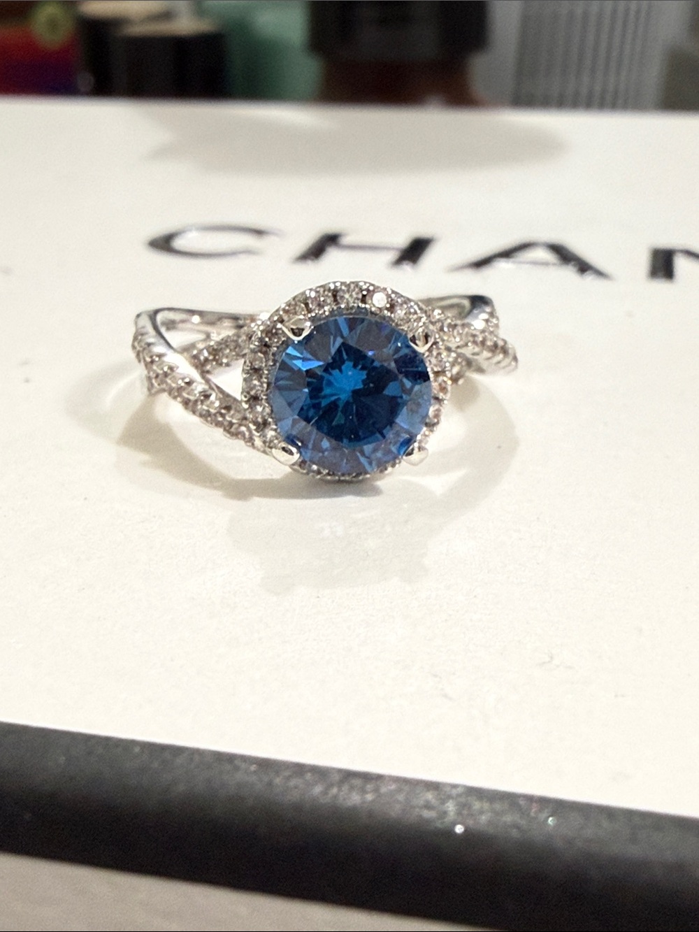 Blue Halo Solitaire Ring with Twisted Pavé Band